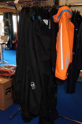 de nombreuses vestes suspendues à un portant dans une pièce
