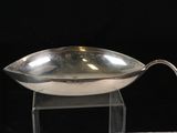 a silver bowl on a clear stand on a black background