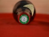 a bottle of wine on a table with a red cloth