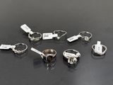 six different types of rings with tags on them on a table