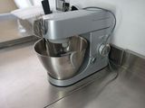 a silver mixer with a metal bowl on the counter