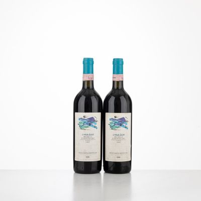 two bottles of red wine sitting on top of a table
