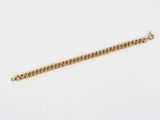a gold chain bracelet with a clasp on a white background