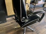 a black chair that is sitting on a hard wood floor