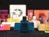 several bottles of perfume are lined up on a table