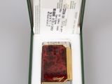 a small box with a small red book inside of it