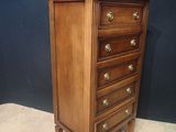 an antique wooden chest of drawers with brass pulls