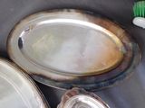 a lot of silver plates and a brush on the table