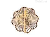 an image of a gold broochle on a white background