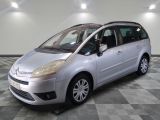 a picture of a silver minivan parked in a garage