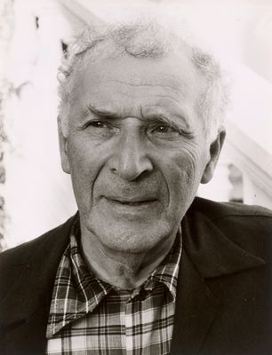 black and white photograph of a man with a plaid shirt and jacket