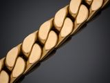 gros plan d'un bracelet en or sur fond noir
