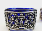 pair of silver and blue glass bangles on a white surface