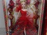 barbie doll in a red dress in a box with a red bow