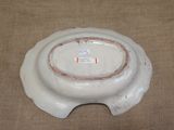 a white bowl with a brown rim on a table