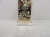 a bottle of perfume sitting on a white surface