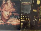two cd ' s of david bowie ' s last album are on the floor