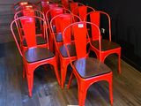 several red chairs are lined up in a row in a room