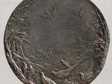 a close up of a metal plate on a wooden table