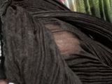a woman that is holding a black dress in her hand