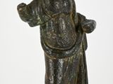 bronze statue of a man with a hat on his head and a robe around his neck
