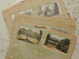 several old postcards are stacked on top of each other on a table