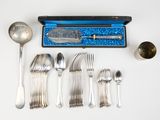 silverware and spoons laid out on a white surface