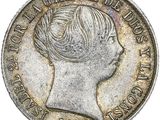 gros plan d'une pièce de monnaie sur laquelle figure un visage de femme