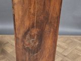 an old wooden cabinet with a marble top sitting on a parquet floor