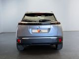 a silver car parked in a room with a white wall