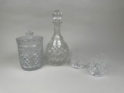 three glasses and a decanter sitting on a table
