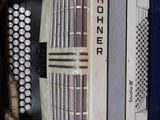 a white accordion sitting on a red shelf in a room
