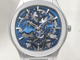 a close up of a watch with a blue dial