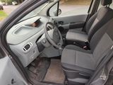 the interior of a small car with a steering wheel and a dashboard