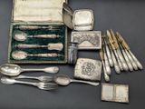 a box with silverware and silver spoons on a table