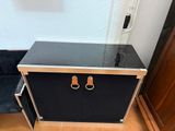 a black cabinet with two leather handles on top of it