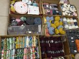 many different types of yarn in boxes on the floor
