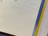 an open book on a table with a pen and paper