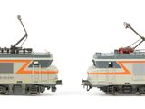 two toy trains on a white surface with a white background
