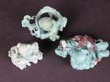 three small figurines that are sitting on a table