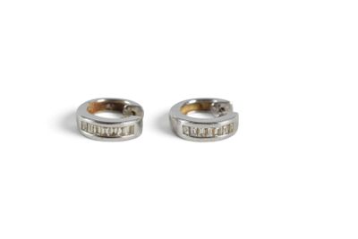 two silver rings with words on them sitting next to each other