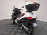 a motor scooter that is parked on a checkered floor