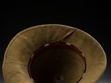 an old hat is sitting on a table in a dark room
