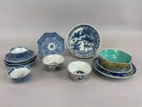 an assortment of blue and white dishes and bowls on a table