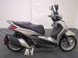 a picture of a motor scooter parked on a checkered floor