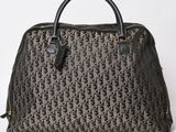 a brown and black handbag with a monogram pattern