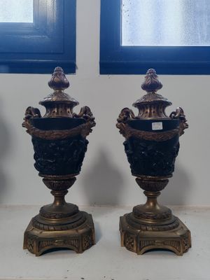 three vases sitting on a table in front of a window