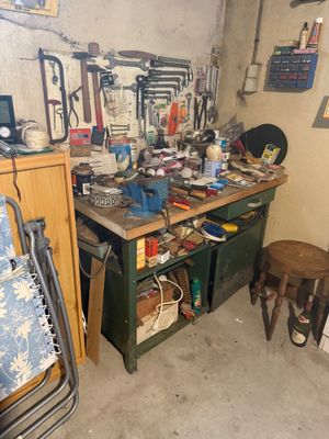 a workbench in a garage with many tools on it