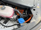 a close up of a car ' s engine with its hood open