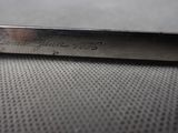 a close up of a metal object with writing on it
